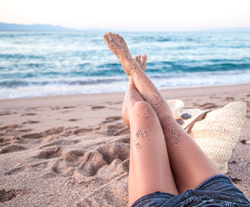 partie-du-corps-pieds-feminins-dans-le-sable-sur-la-plage